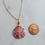 Thumbnail: Pink and white scallop shell wrapped in gold wire on a gold paperclip chain necklace
