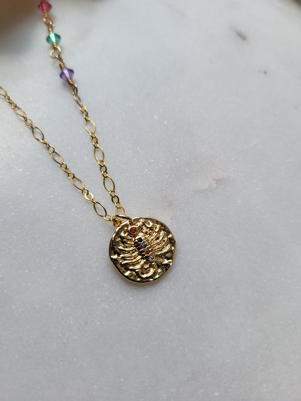 Thumbnail: Gold necklace with gold scorpio zodiac sign medallion and wire wrapped swarovski crystals