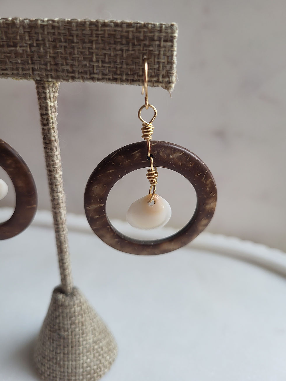Thumbnail: Coconut shell dangle hoop earrings with gold wire wrapped seashells