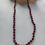 Thumbnail: Red garnet beaded necklace on red silk knotted cord