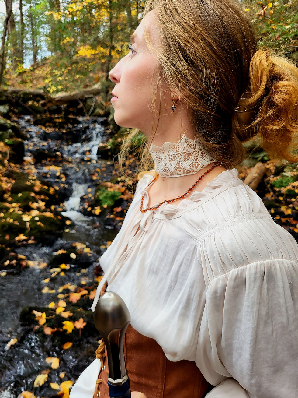 Thumbnail: Woman wearing fantasy outfit with orange hessonite garnet necklace