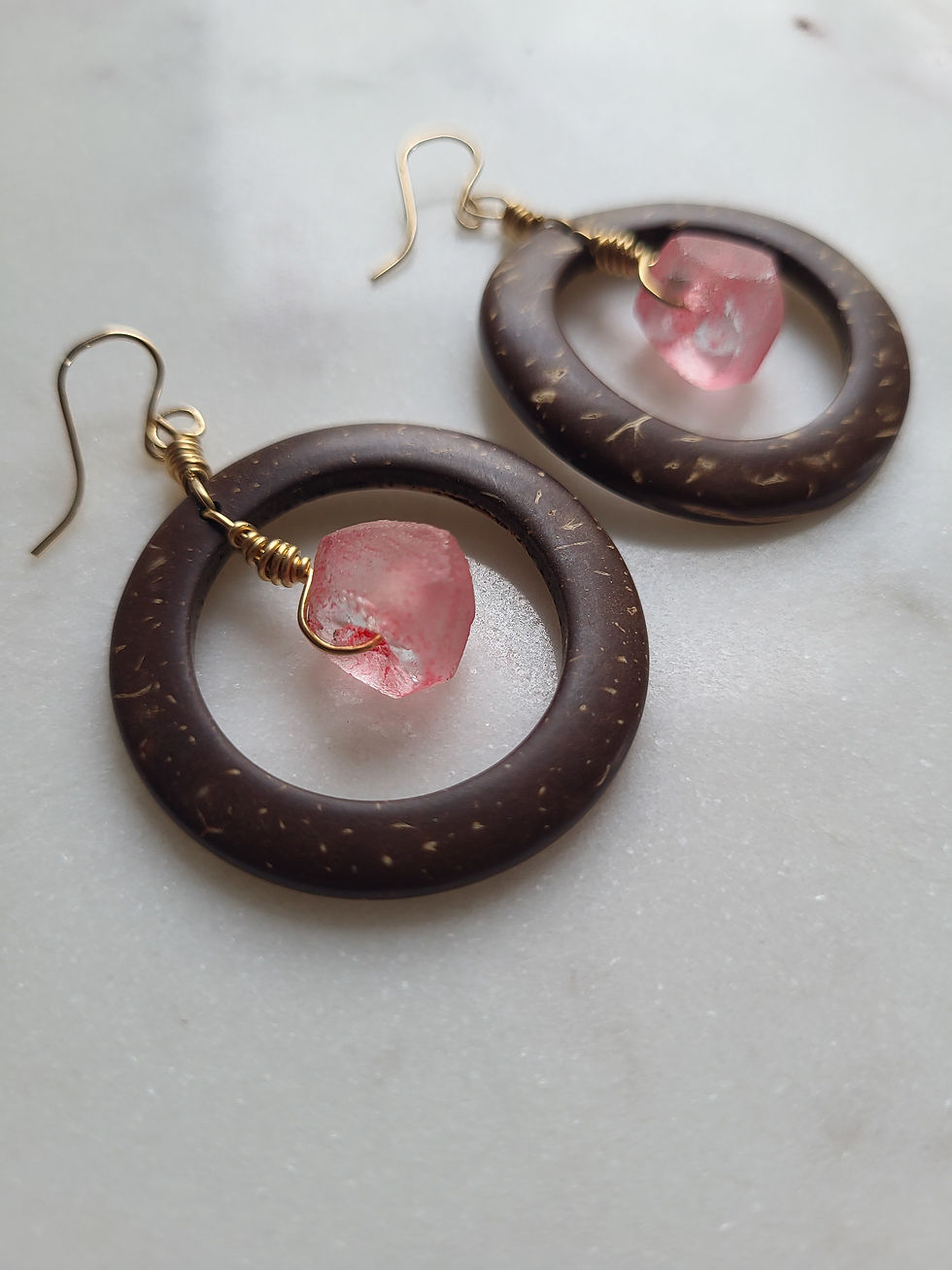 Thumbnail: Coconut shell dangle hoop earrings with gold wire wrapped pink glass beads