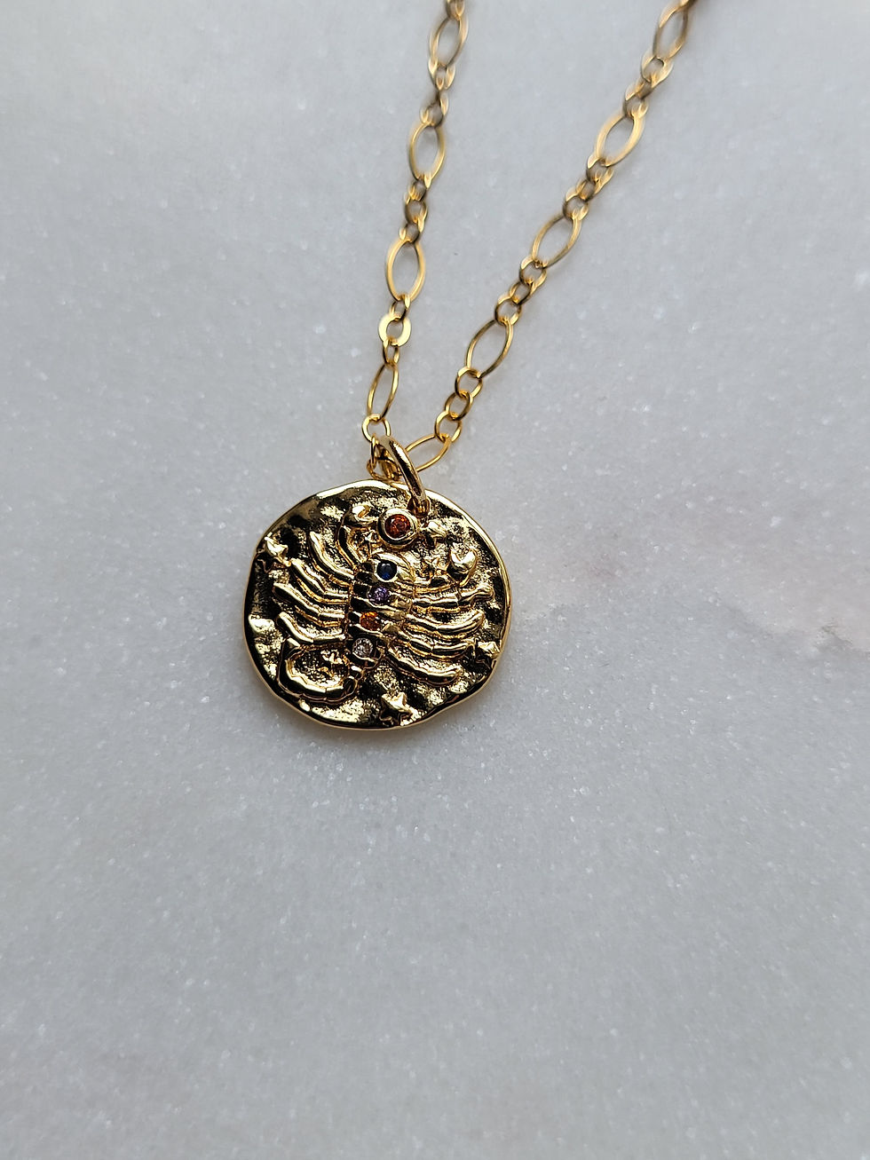 Thumbnail: Gold necklace with gold scorpio zodiac sign medallion and wire wrapped swarovski crystals