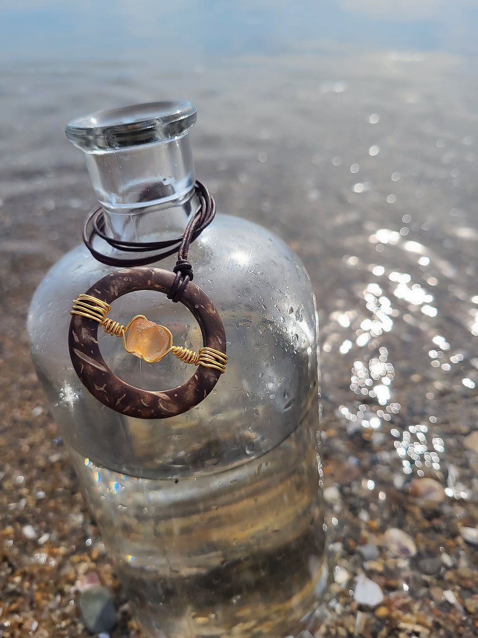 Thumbnail: Coconut shell medallion necklace with a gold wire orange glass piece