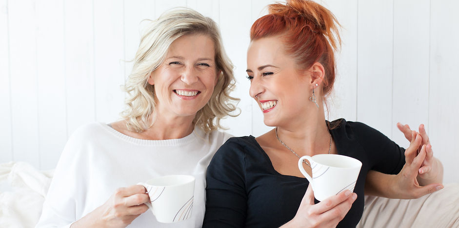 Women of different generations sitting and laughing together