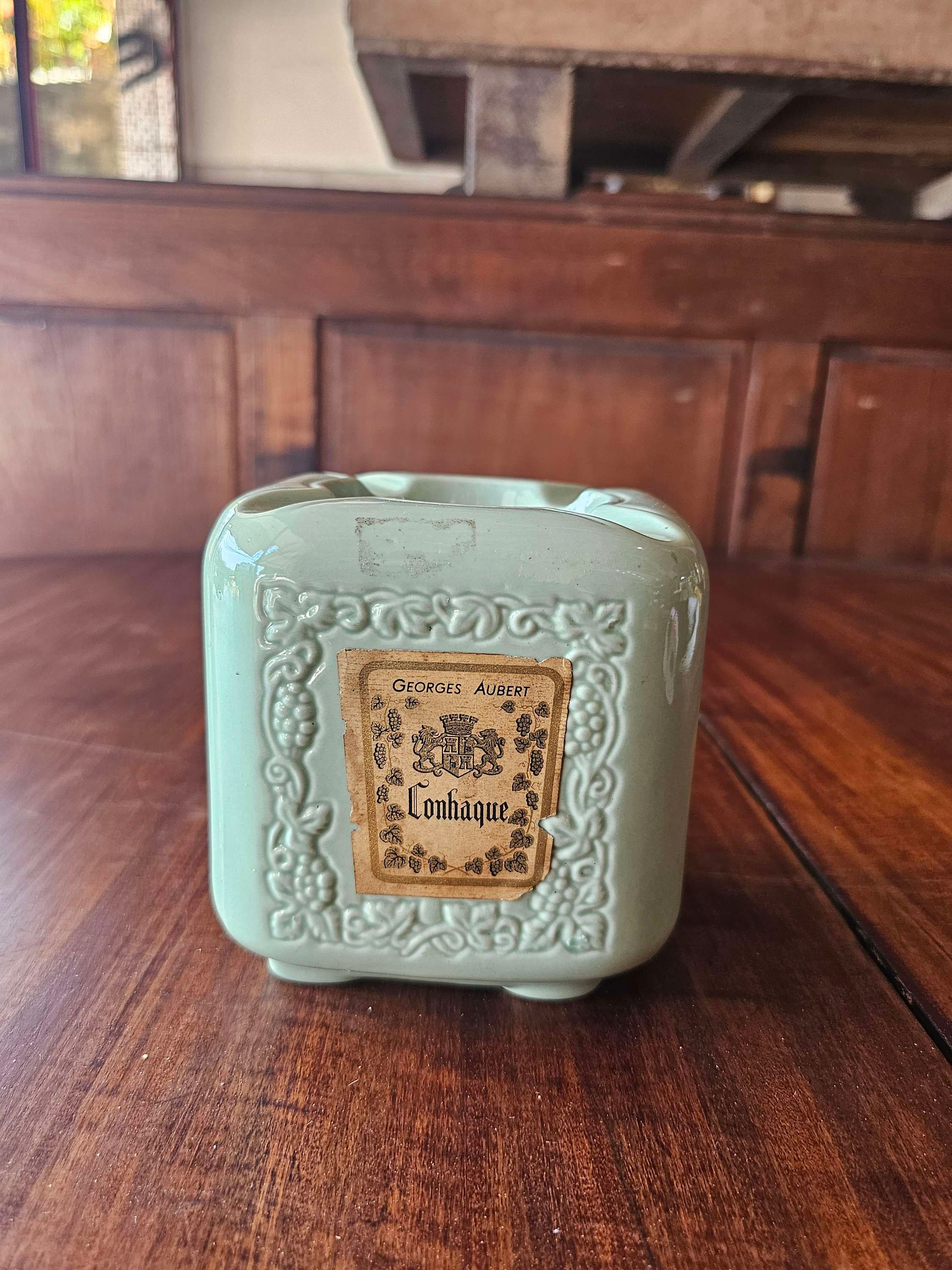 "Antiga garrafa de conhaque que se transforma em cinzeiro, feita em porcelana refinada. Esta peça única apresenta um design criativo e detalhado, combinando funcionalidade e estilo vintage. Ideal para colecionadores e amantes de itens exclusivos, trazendo um toque de sofisticação e nostalgia a qualquer ambiente."