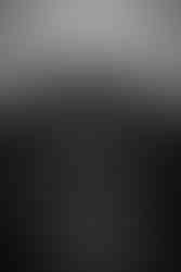 Black and white photo of humayun's tomb in the background with a man standing in the foreground