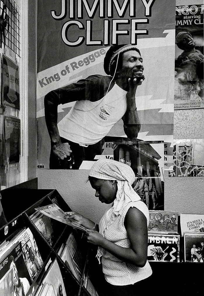girl_selecting_a_record__beneath_jimmy_cliff_poster__in_record_shop-_photo_by_richard_saun