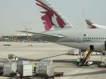 Qatar airline carrier on the tarmac on a sunny day