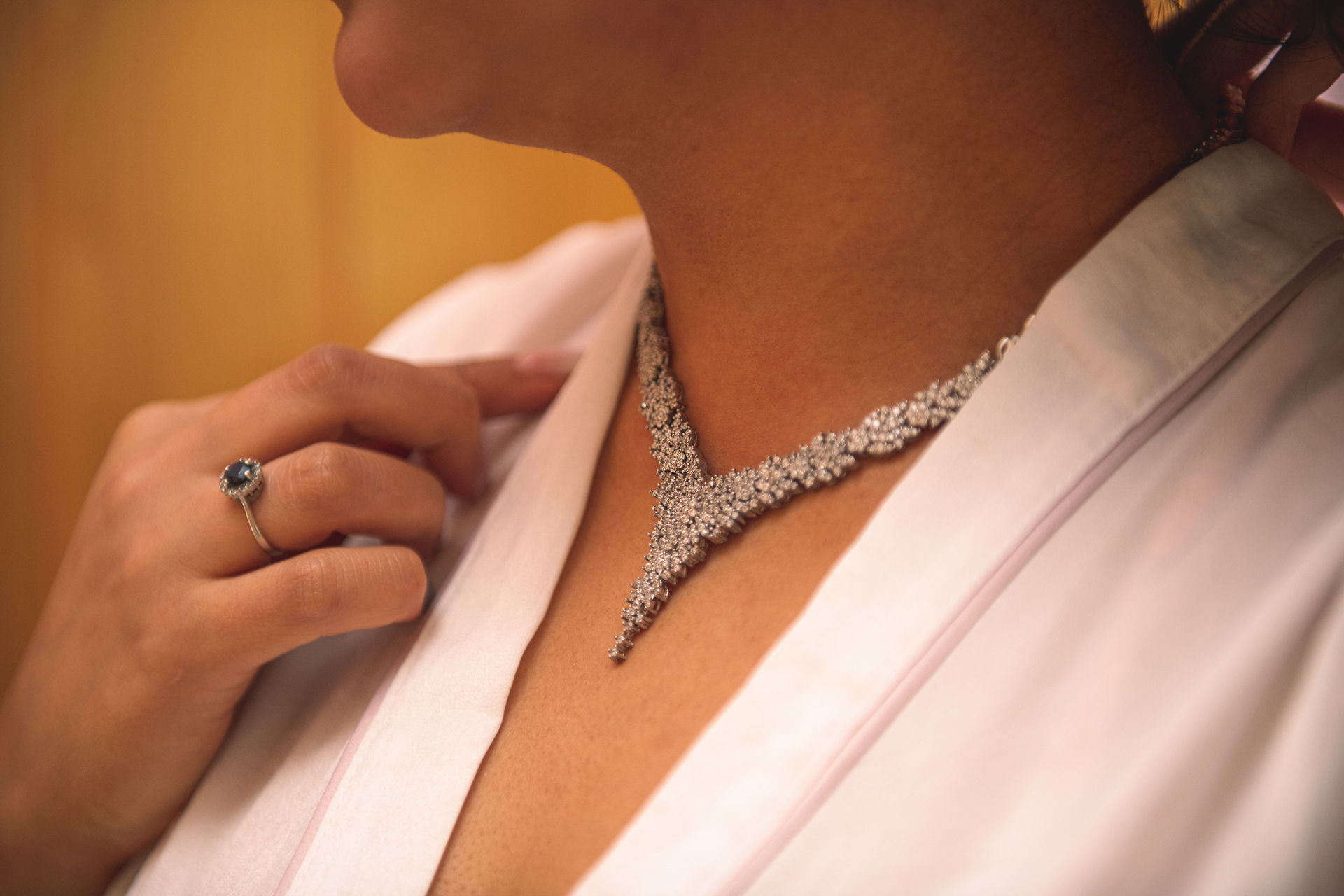 Closeup of the bride's necklace at a wedding at Canada Lodge & Lake, Cardiff, by Swansea wedding photographer Katy Tainton Photography