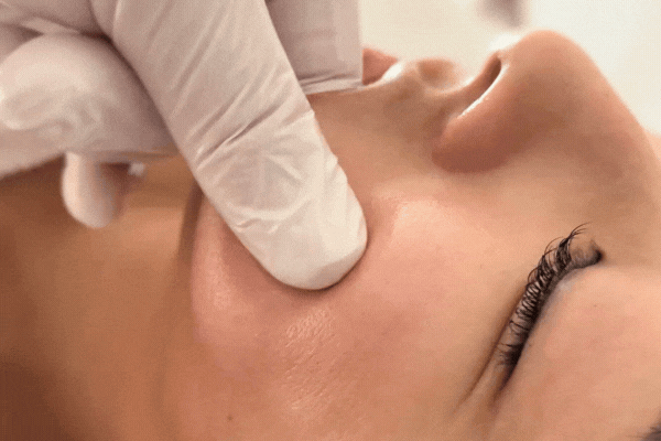 Instructor demonstrating external Buccal Massage on a student’s jaw muscles during hands-on TMJ training in Franklin, Tennessee, highlighting proper masseter release techniques discussed in the article.