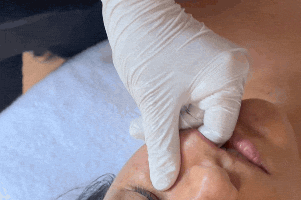 Instructor-led buccal massage training in New York with students learning corrective facial massage and TMJ-focused techniques.