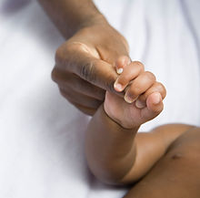 A black baby's hand holding a black mother's finger- white background