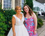Female wedding singer performing live with acoustic guitar and harmonies.