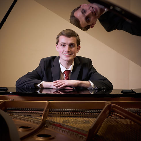 sam keily sitting at piano churubusco indiana