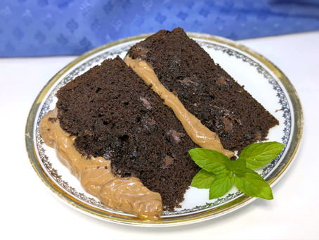 homemade chocolate choc chip cake with creamy choc peppermint frosting with mint leaves