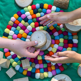 hands over colourful mat