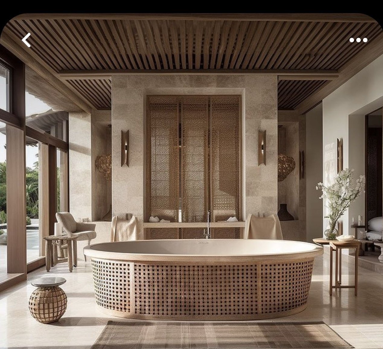 a large bath tub sitting inside of a bathroom next to two chairs and a table