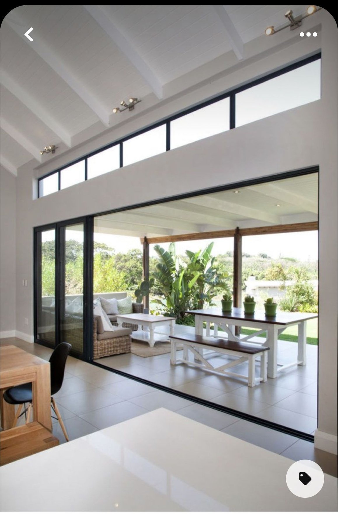 an open living room and dining area with sliding glass doors