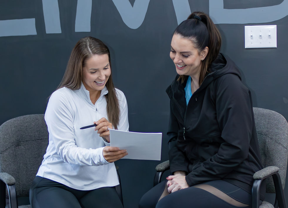 Health Coach working collaboratively with a client, discussing personalized plans for nutrition, fitness, and a healthier lifestyle.