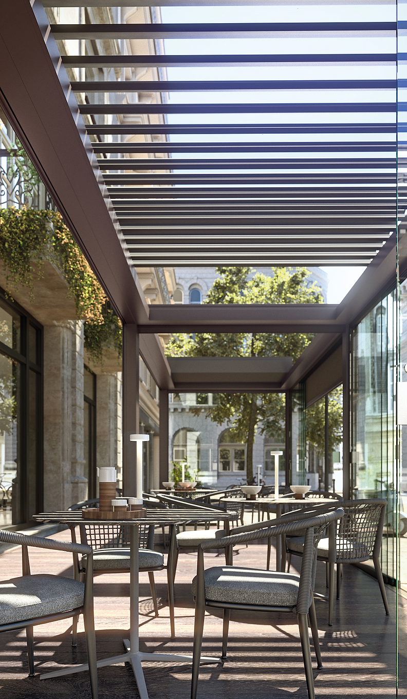 Pergola Bioclimatica installata per una pasticceria. La struttura è in alluminio, color marrone. La copertura è composta da lame retraibili, qui sono aperte. Perimetralmente è chiusa con vetrate scorrevoli. All'interno ci sono tavolini e lampade bianche