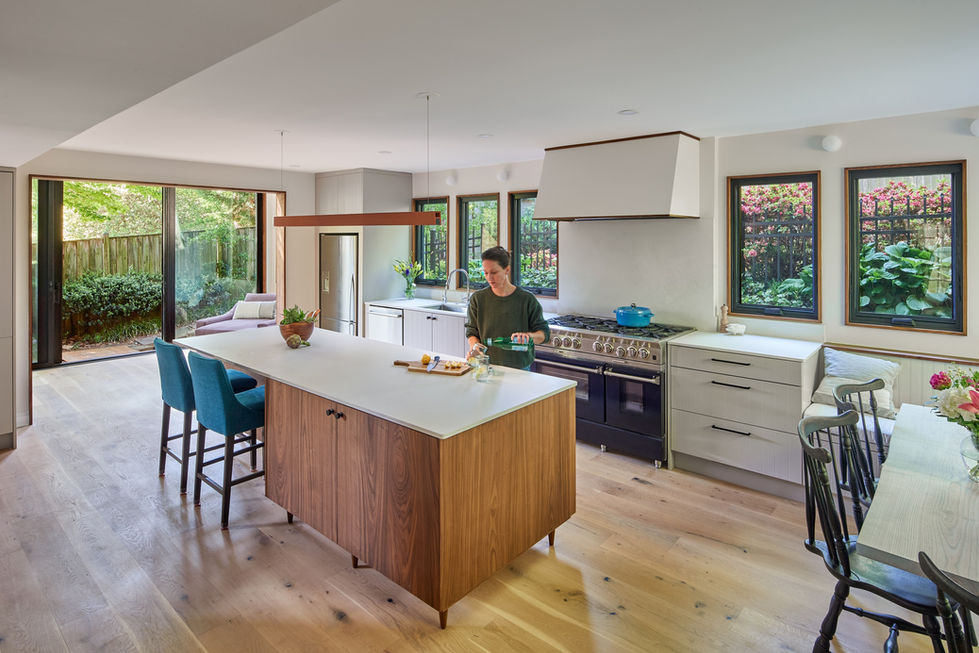 Kitchen island with seating, gas range, lots of windows