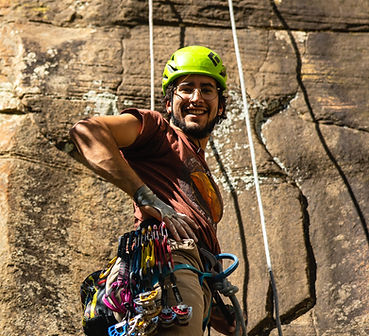Guide Walker racked up with trad gear ready for a climb.