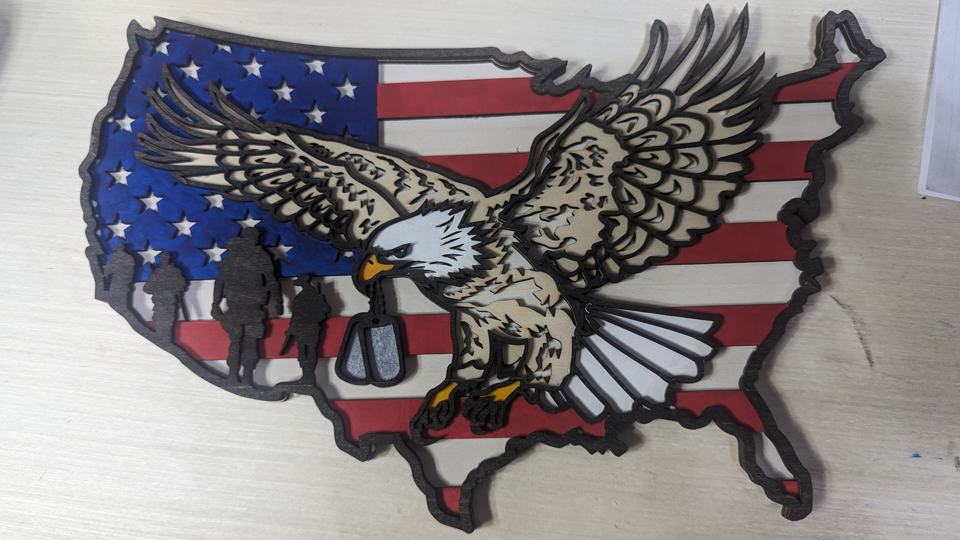Patriotic eagle carrying dog tags over USA map