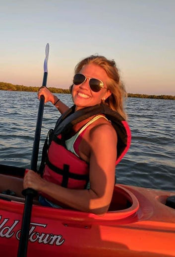 I am kayaking on a lake in Florida while watching the sun go down feeling rejuvenated and loving life.