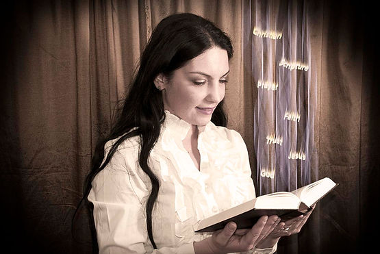Photograph of a young woman reading the Bible from which spiritual words float upwards, illustration for: A lot of fear in Faceoffs with Bad Thoughts.