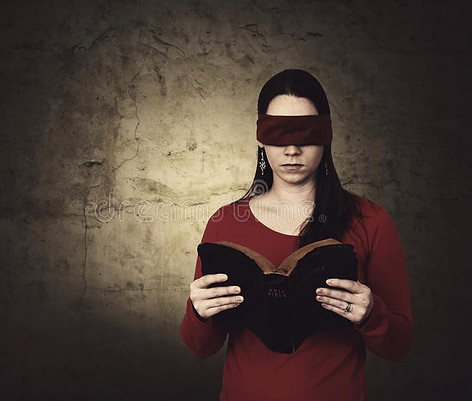Photograph of a young woman reading the Bible with a blindfold over her eyes, for the subject Reading the Old Testament with a veil over the eyes, not understanding it was abolished.