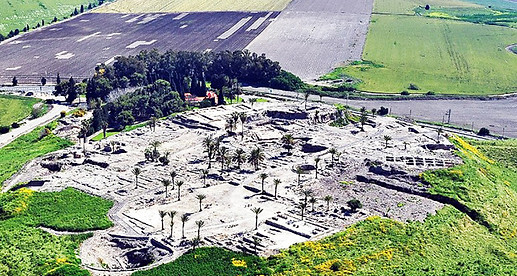 An aerial photograph of the ruins of Tel Megiddo in northern Israel overlooking the fertile Jezreel Valley.