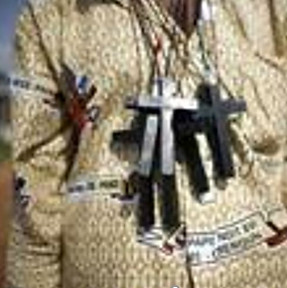 Image of a person with silver and black crucifixes on his chest, illustration for the Commenatary on the number 666 of the Second Beast of Revelation by Dewayne Shappley.