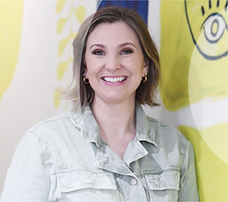 Close up of Emma smiling and looking happy in a denim jumpsuit
