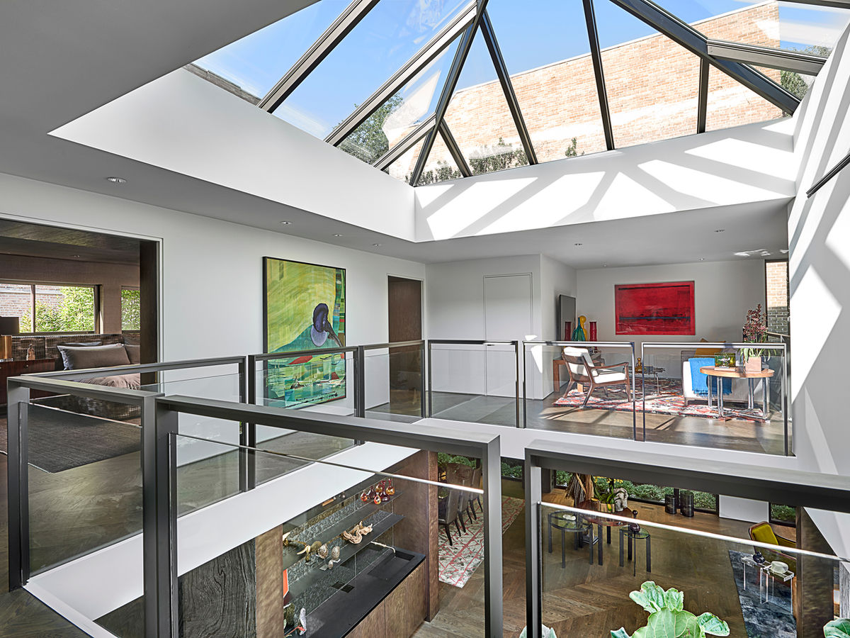 Two-story atrium with a glass roof in modern home.