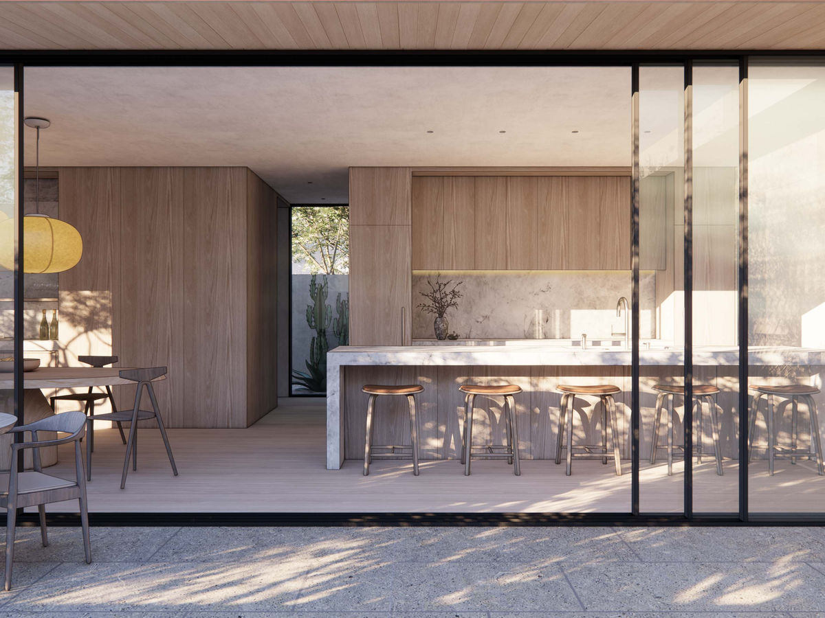 Indoor–outdoor kitchen and dining space at the Case Study 2.0 Palisades fire-rebuild home. Sliding glass walls open fully to the pool terrace, revealing warm wood cabinetry, marble surfaces, and modern lighting. The design blends resilience, sustainability, and refined organic modern aesthetics.