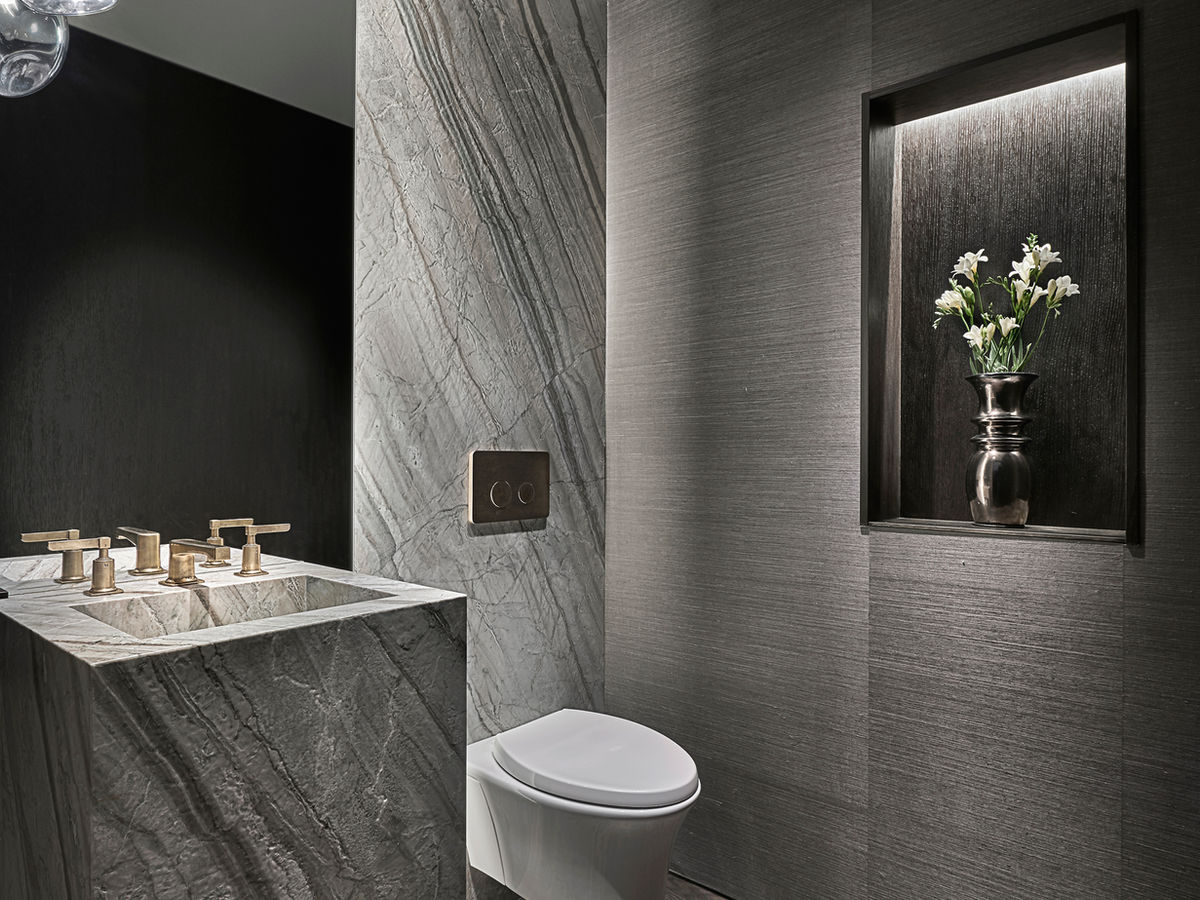 Bathroom in grey palette with vase inset in wall.
