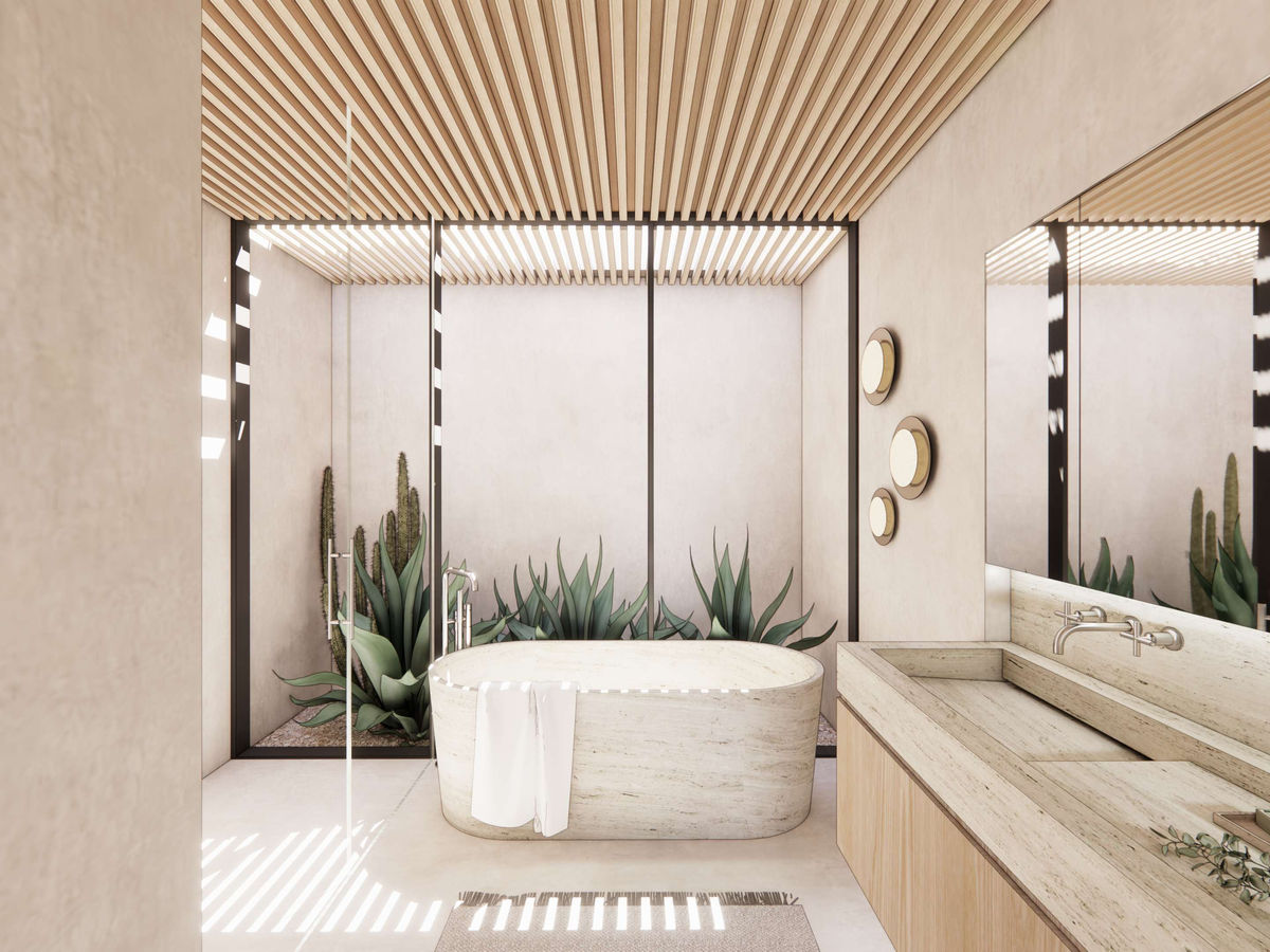 Primary bathroom with stone soaking tub, skylight, and glass wall facing low-water succulent courtyard.