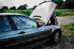 car repair, broken down, broken down car, man fixing car, roadside assistance, under the hood, old car, hubcap, engine problems