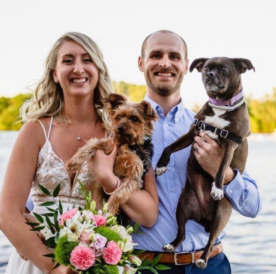 wedding couple by lake, pink wedding bouquet, happy bride, dog wedding photo, pet wedding photo