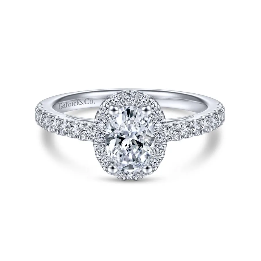 white gold oval engagement ring with halo and diamond shank