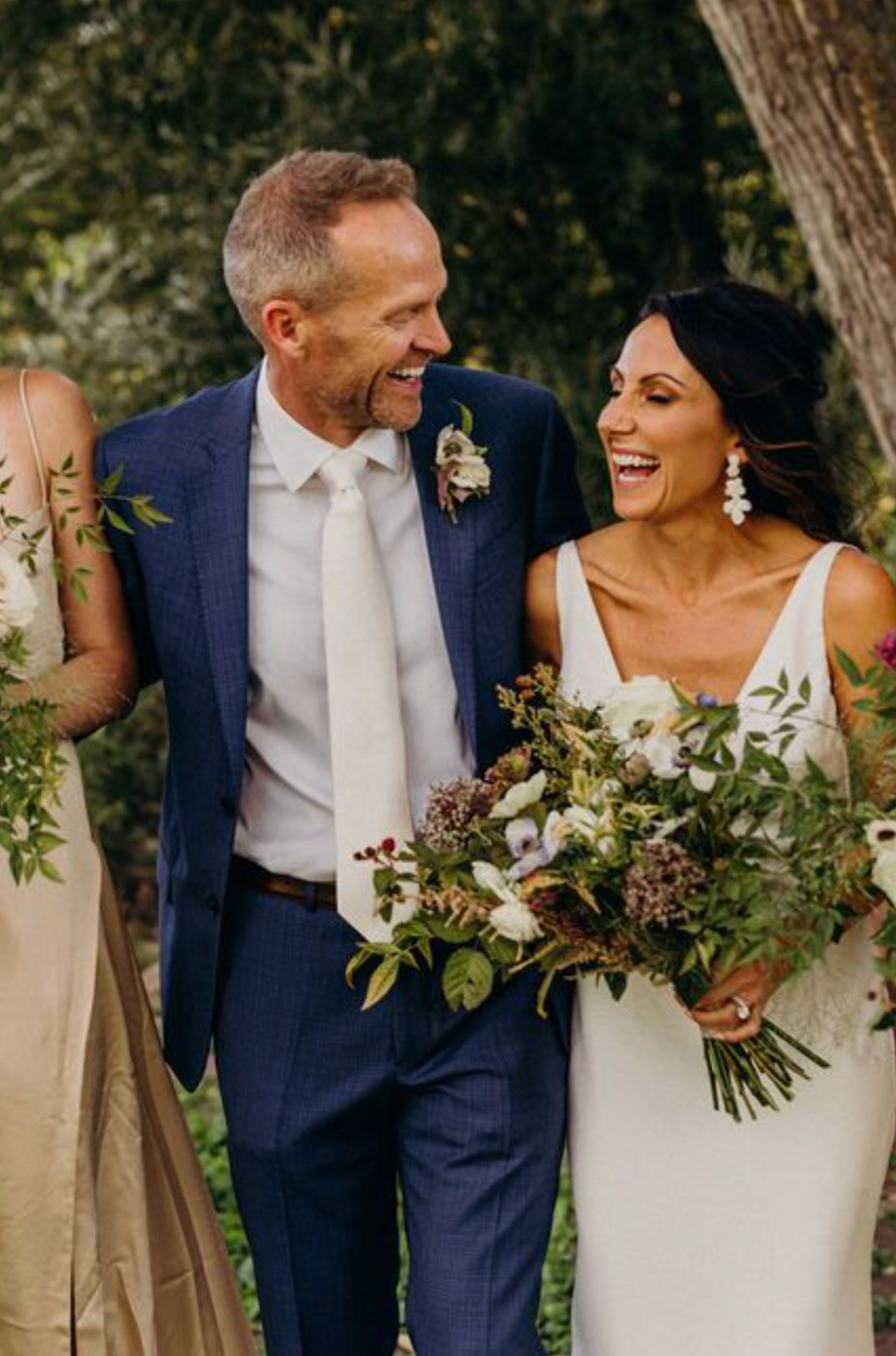 man in blue suit, white tie, bride, wildflower bouquet, groom, wedding style, outdoor wedding, second wedding, older wedding couple