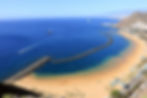 Sunny beach in Tenerife with palm trees and blue ocean – ideal winter sun holiday from Dublin