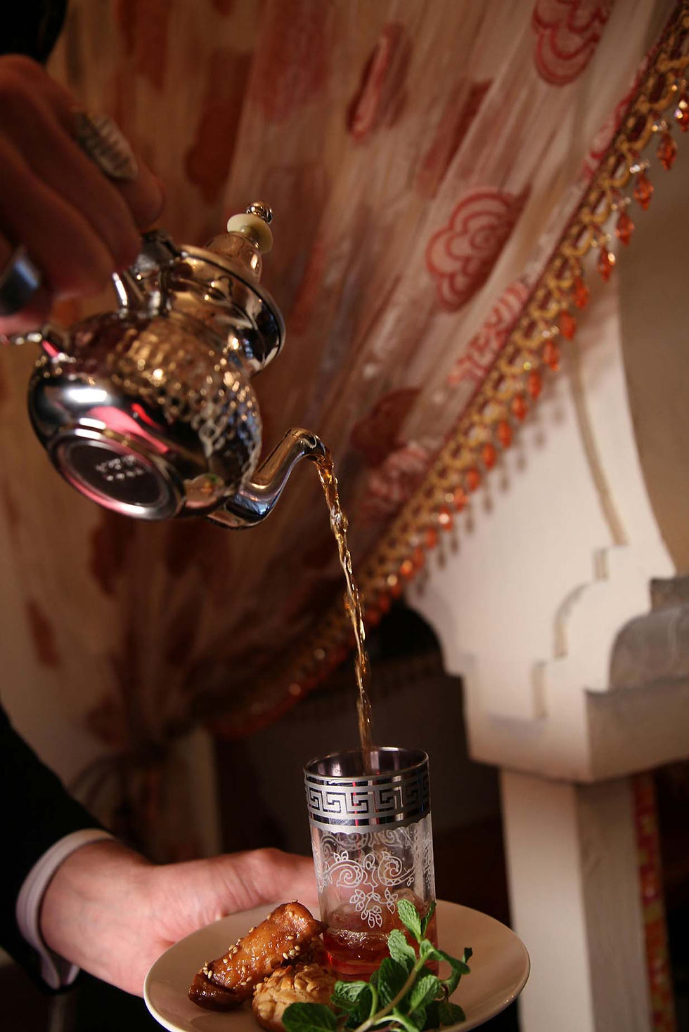 Traditional Moroccan mint tea served in a silver teapot with fresh mint