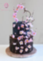 Two tier rustic tree stump cake with navy top tier wedding cake. Cherry blossom flowers.