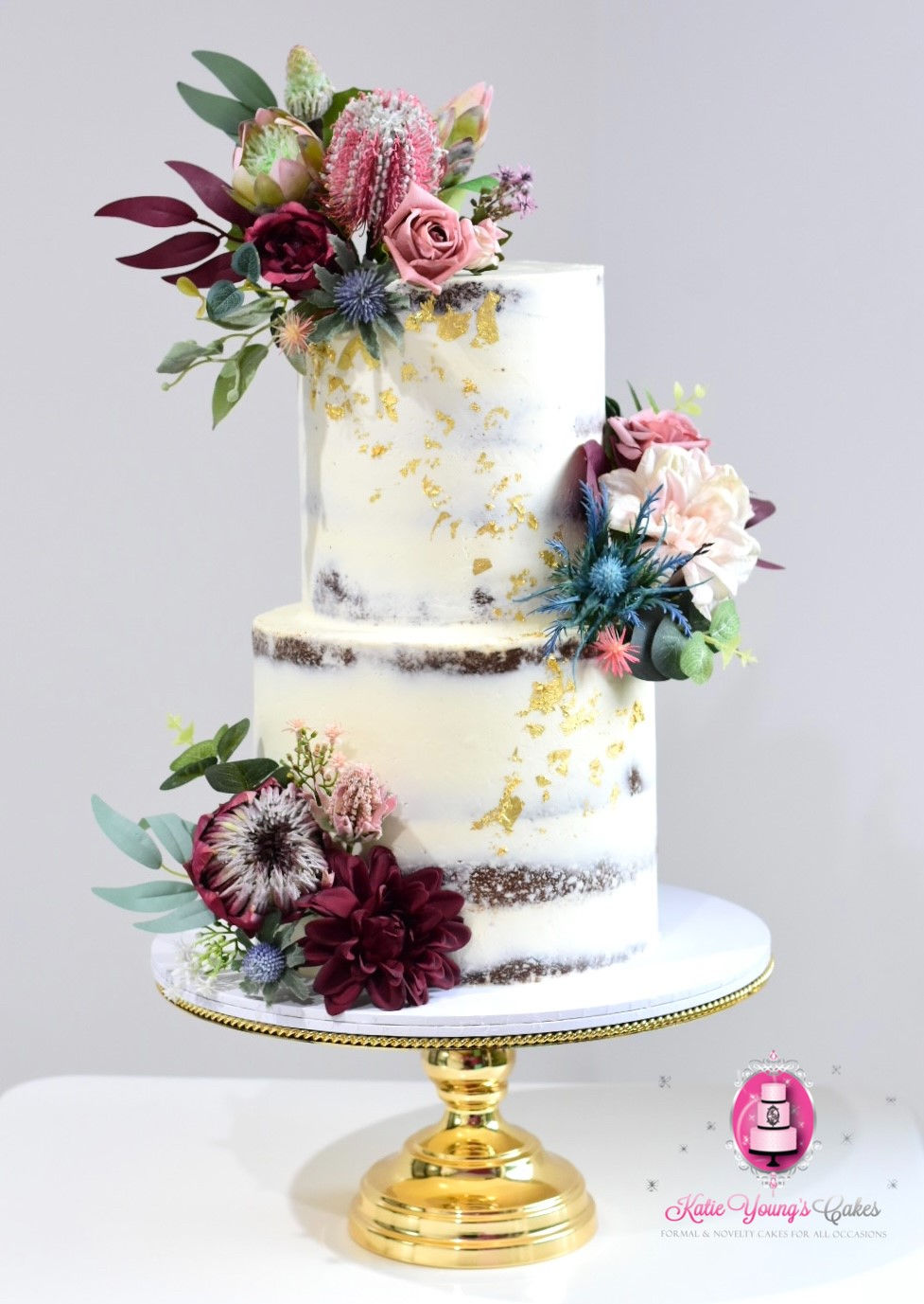 Rustic two tier semi naked wedding cake with native flowers