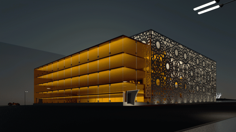 Pushkinsky Cinema façade illuminated in yellow lighting.