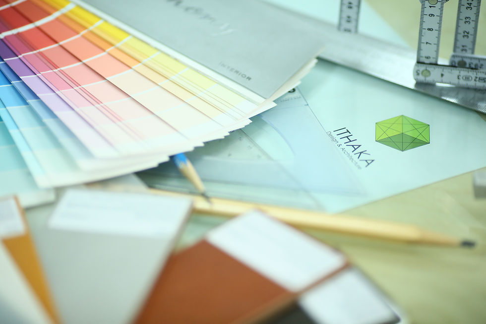 Close-up of design sketches alongside an interior color and materials catalogue, showing samples and creative planning tools.