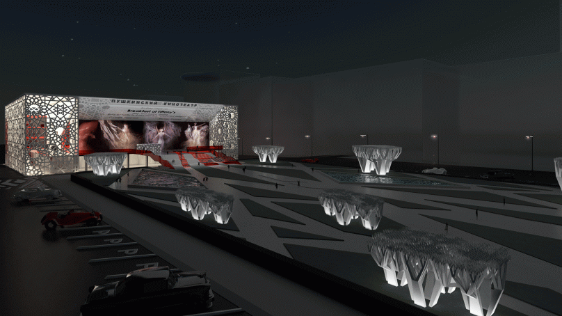 Aerial night view of Pushkinsky Cinema with illuminated façade.