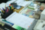 An image picturing the creative atmosphere of the creation process with various art media